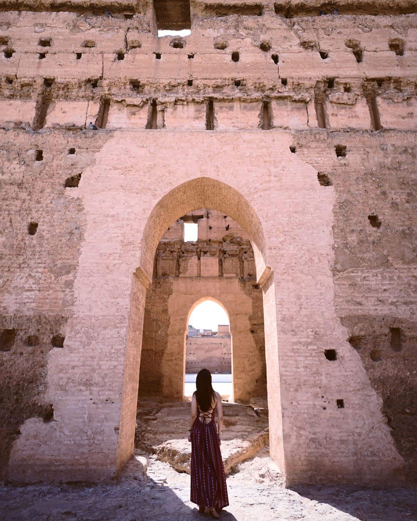A women stadning in the main gate of El Badii-Ksibat Nhass Palace