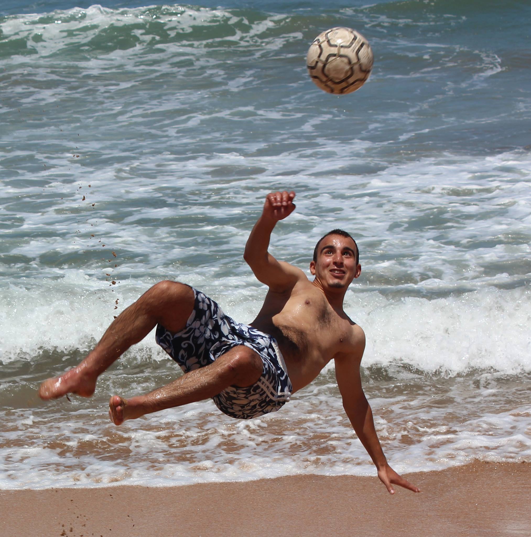 a guy playing football in Bouznika is a city halfway between Rabat and Casablanca. 5 kilometers long, Bouznika beach is very popular with Moroccans.